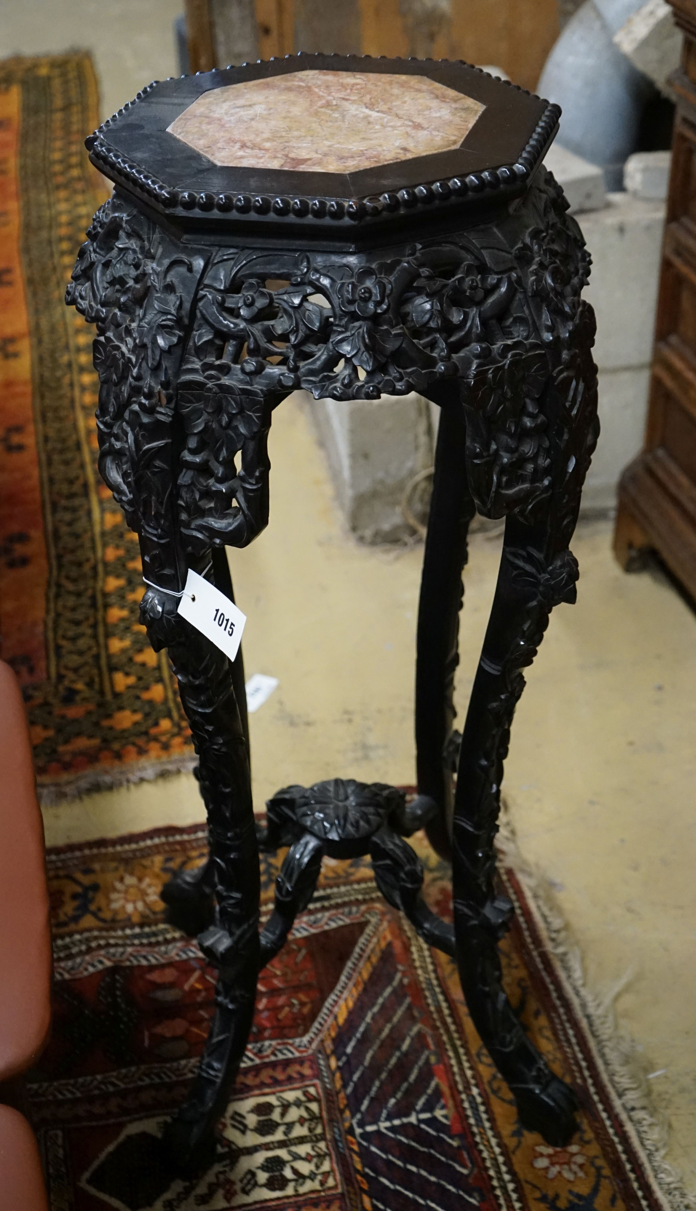 A Chinese carved hardwood marble top octagonal vase stand, width 40cm, height 90cm